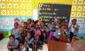 Kendrah and another classmate with a group of children.