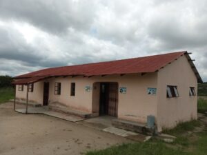 Drop-In Center, a tan building with a red roof.